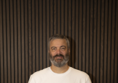 Chris Salt, ADHD coach at ADHdifference Coaching, standing and smiling with ADHD books
