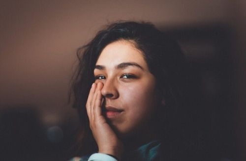 woman with hand on face