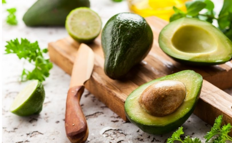 Open avocado on chopping board