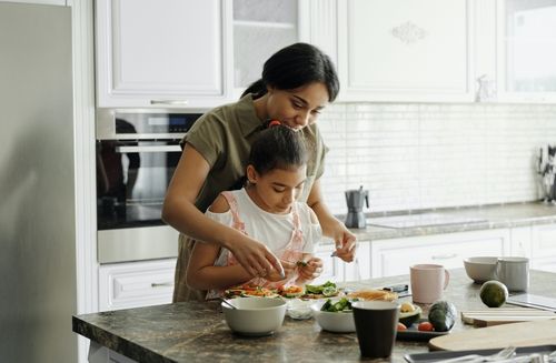 woman cooking with child