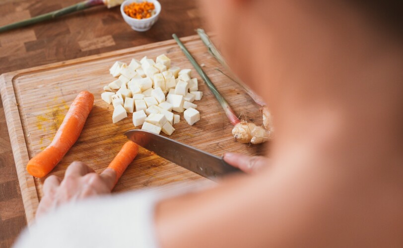 Woman chopping carrots